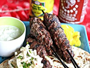 Grilled beef kebabs, served on flatbread over onion salad with a ramekin of yogurt-mint sauce.