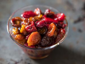 a bowl of red and yellow oven-roasted tomato raisins