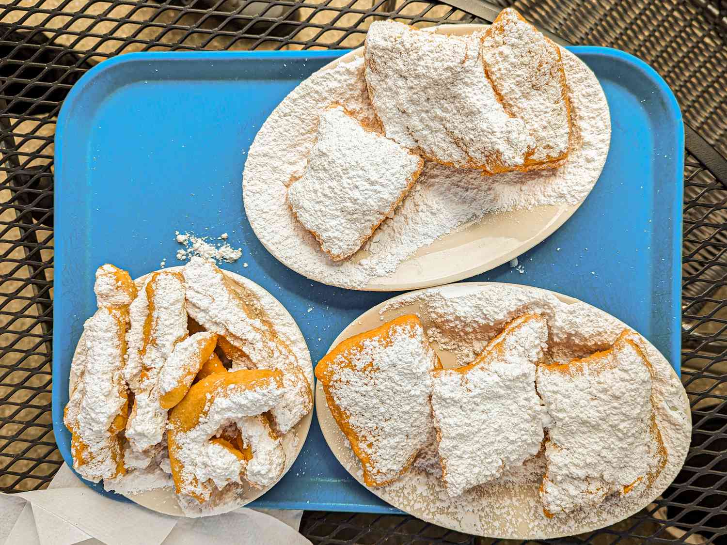 Overhead view of beignets on a platter