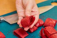 A person holding spiral food leather