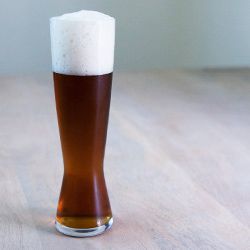 A tall pint glass of amber-colored Oktoberfest.