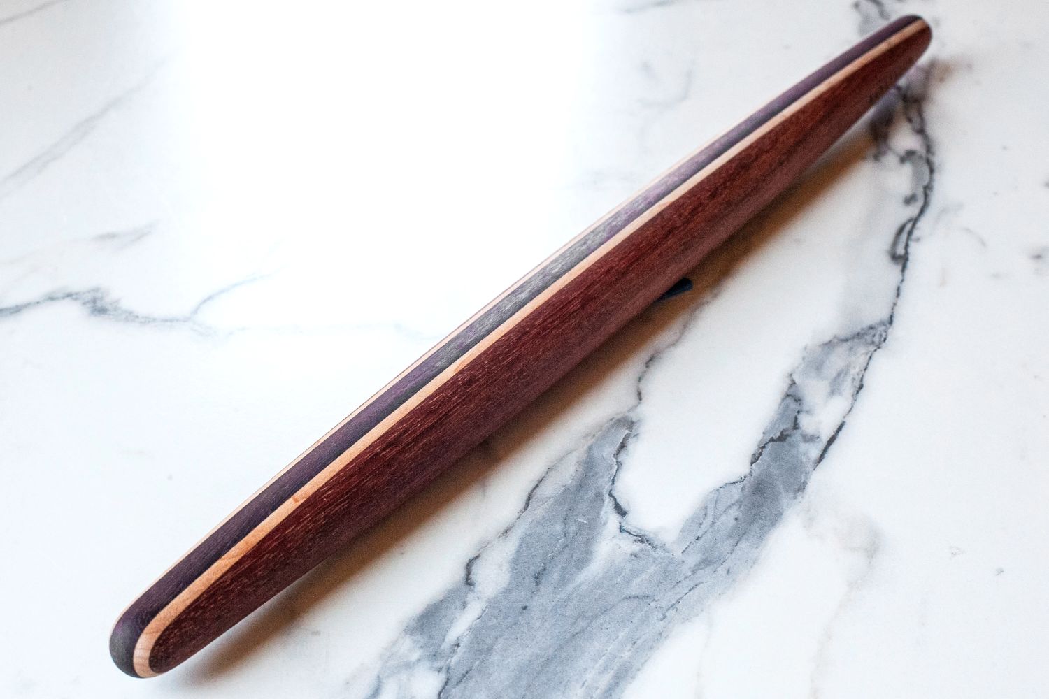 Earlywood French Rolling Pin with a smooth finish resting on a marble surface