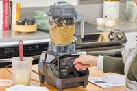 A hand turning a nob on the Vitamix E310 Explorian Blender