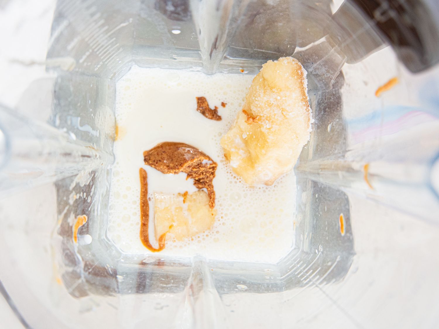 Ingredients for banana smoothie in a blender.