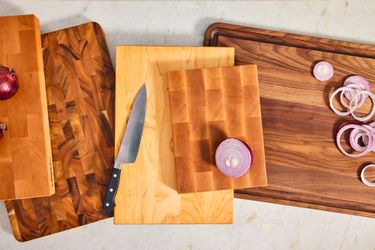 A collection of wooden cutting boards on a white background