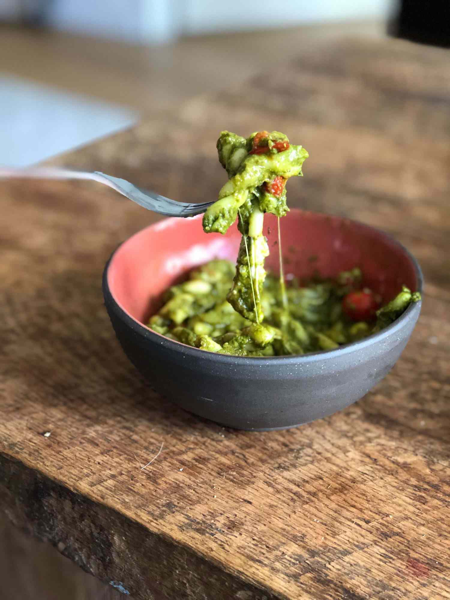 Bowl of gemelli with pesto and cherry tomatoes