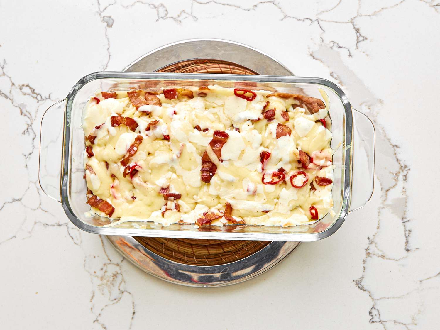 Overhead view of queso fundido in a pyrex loaf pan.