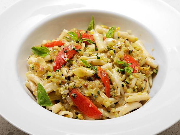 Summer ratatouille with pasta, served in a white porcelain bowl.