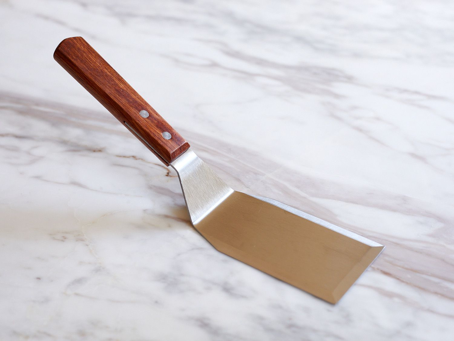 Mannkitchen turner on a marble countertop