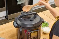 A person releases pressure from the Instant Pot Pro 10-in-1 6-Quart Pressure Cooker