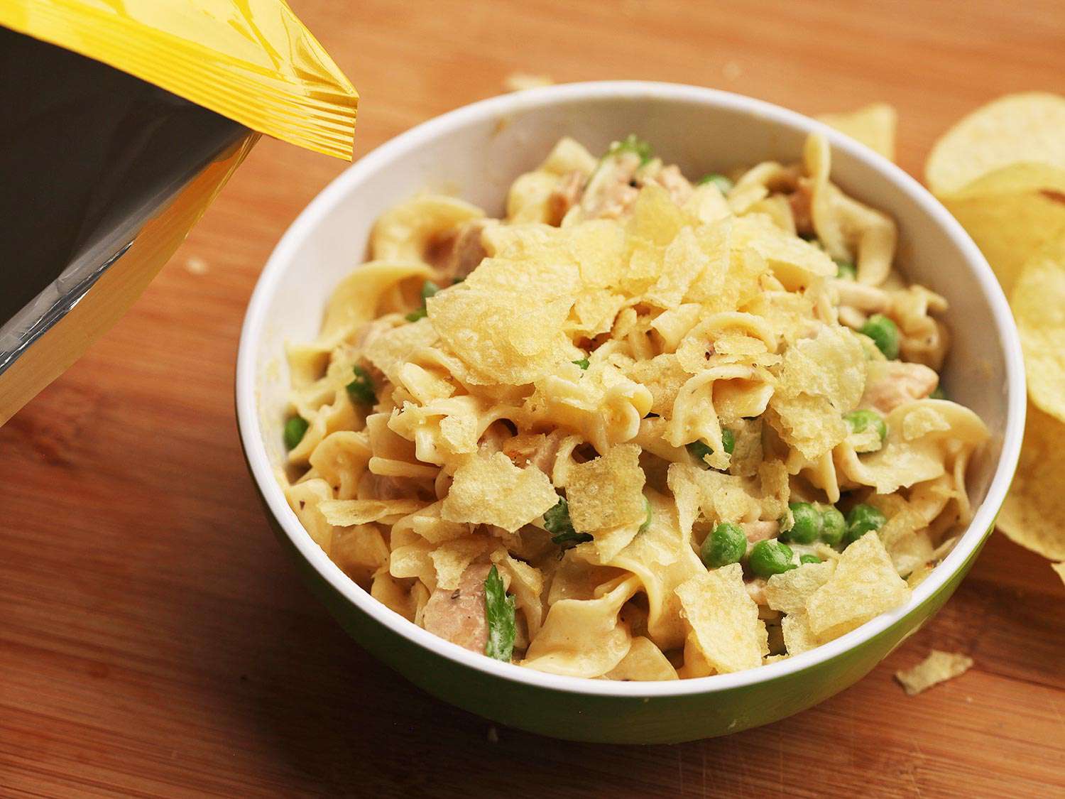 A bowl of tuna noodle casserole topped with crushed potato chips