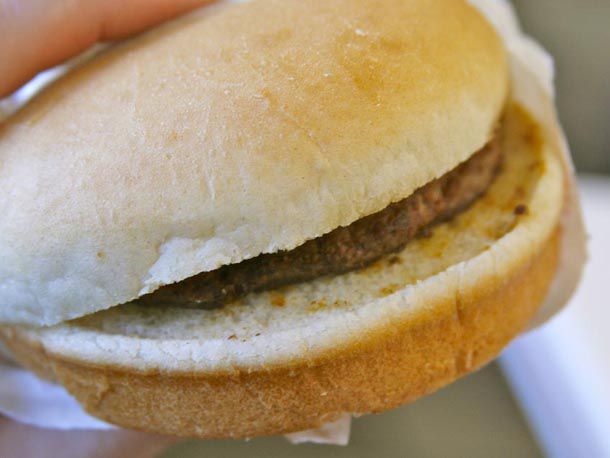 A plain hamburger that is just the bun and a patty