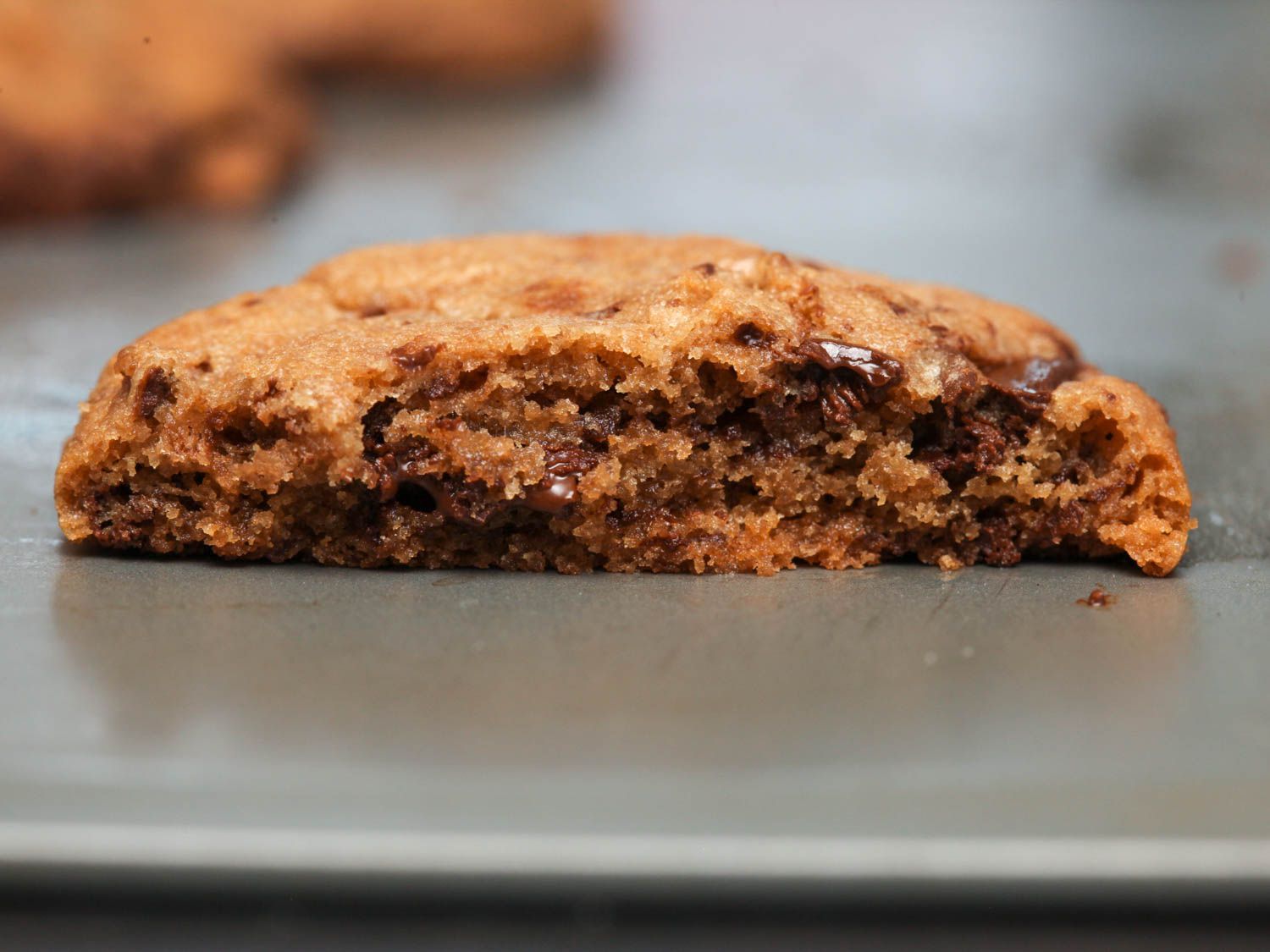 Close-up of the interior of a halved chocolate chip cookie.