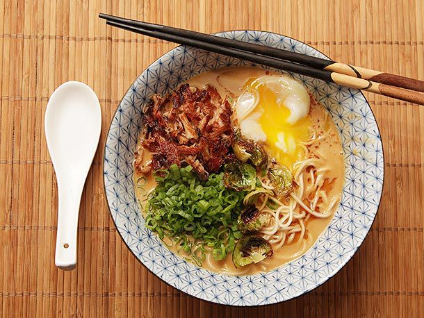 Turkey paitan ramen, served with soft-boiled egg, crispy turkey and scallion in a bowl. 