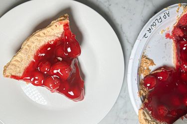 Cherry pie slices on different plates one labeled with flour type