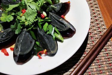 Overhead view of century egg salad, served on a plate.