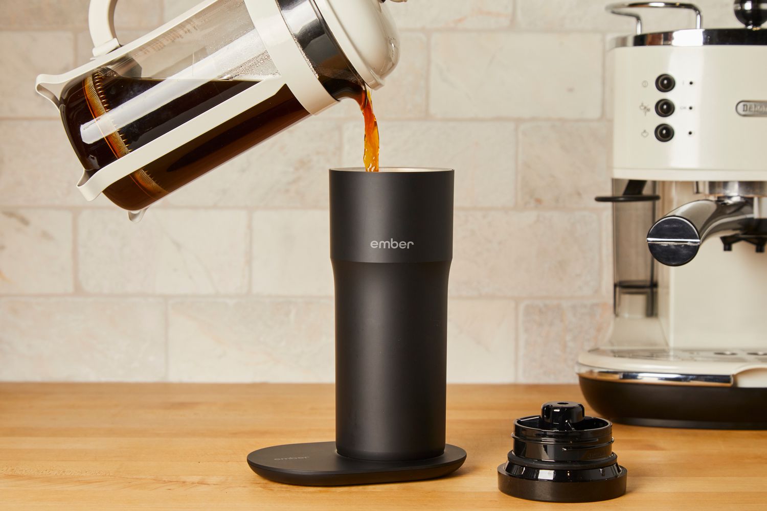 Person pouring coffee into Ember Travel Mug 2