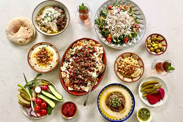 Overhead view of tablescape of multiple hummus plates