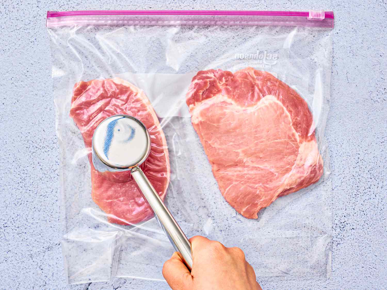 Overhead view of pounding pork