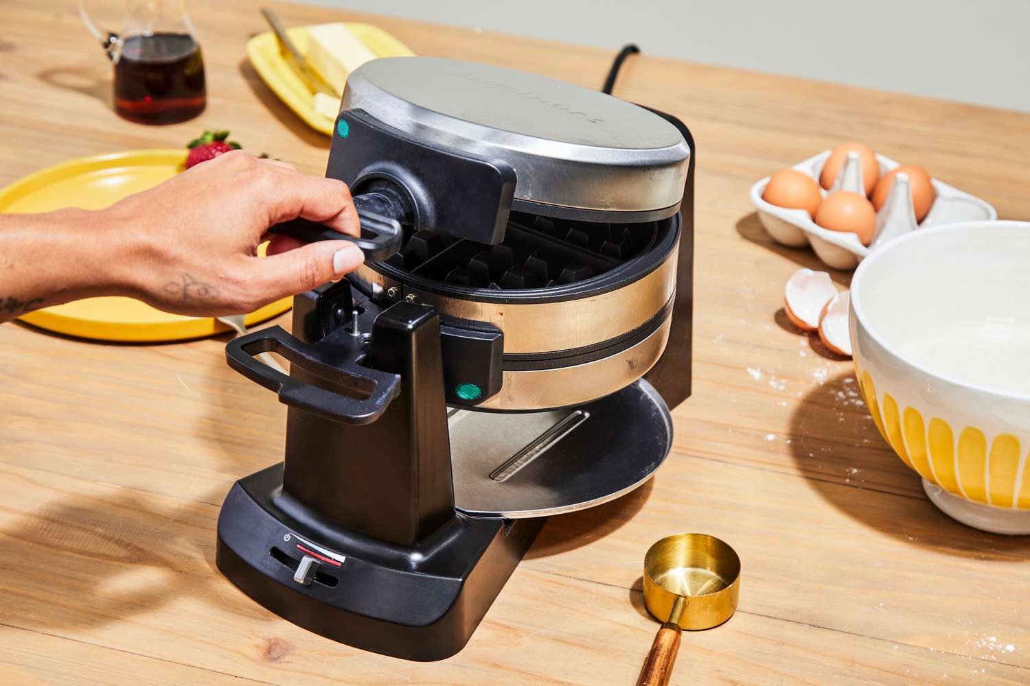 Person closing Cuisinart WAF-F4 Double Flip Belgian Waffle Maker