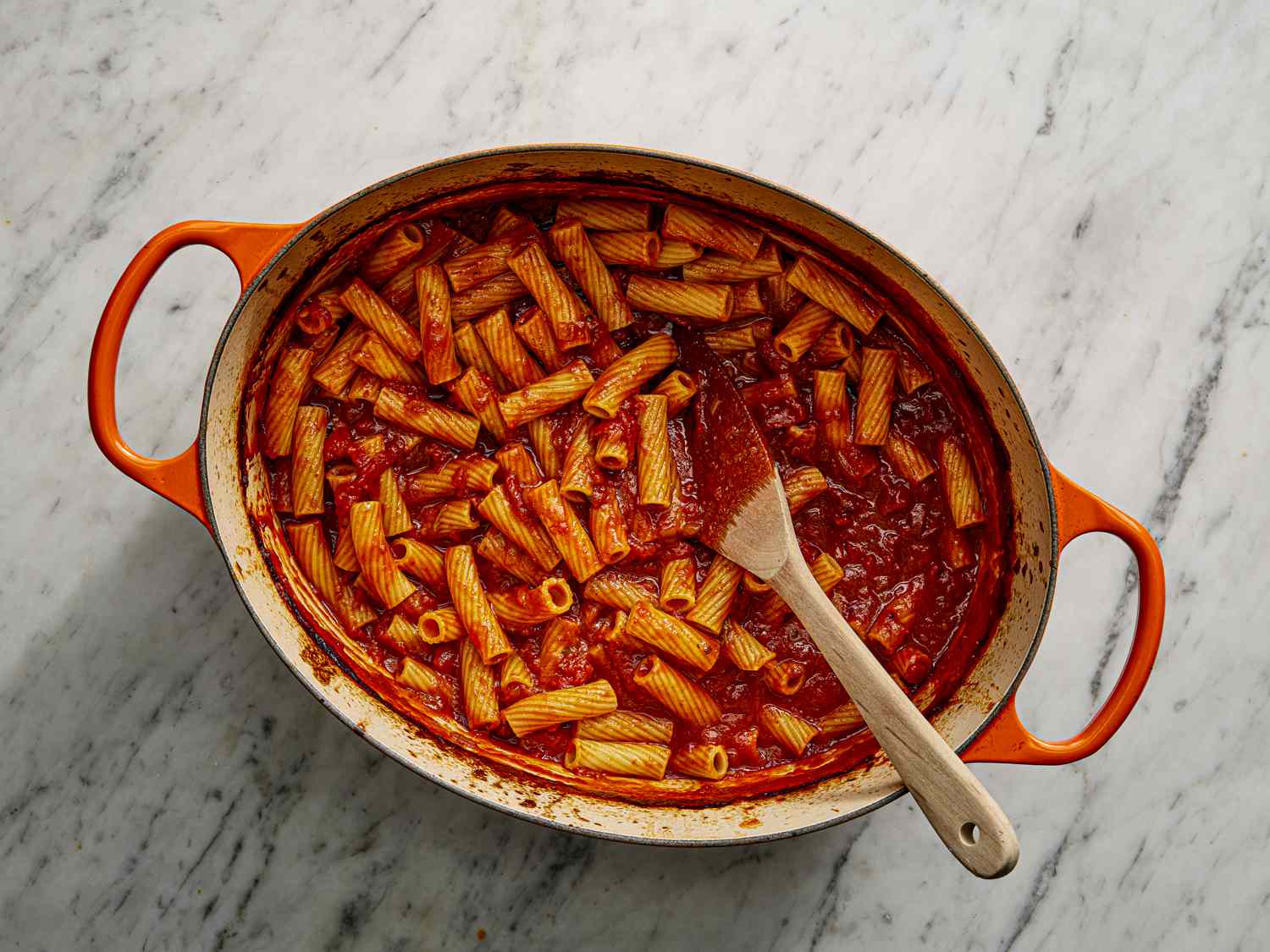 Pasta added to sauce in dutch oven