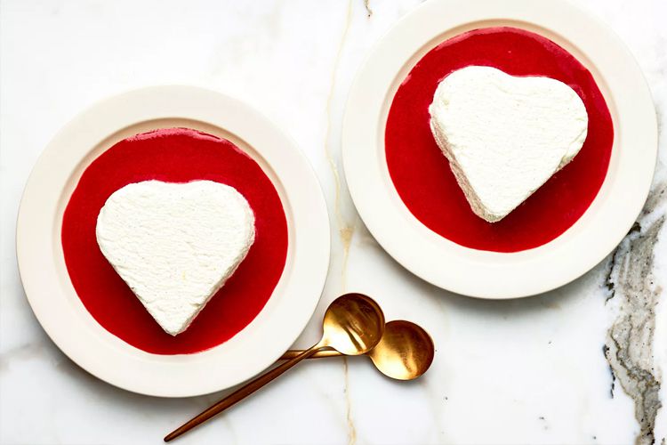 Overhead view of two coeur a la creme with strawberry sauce