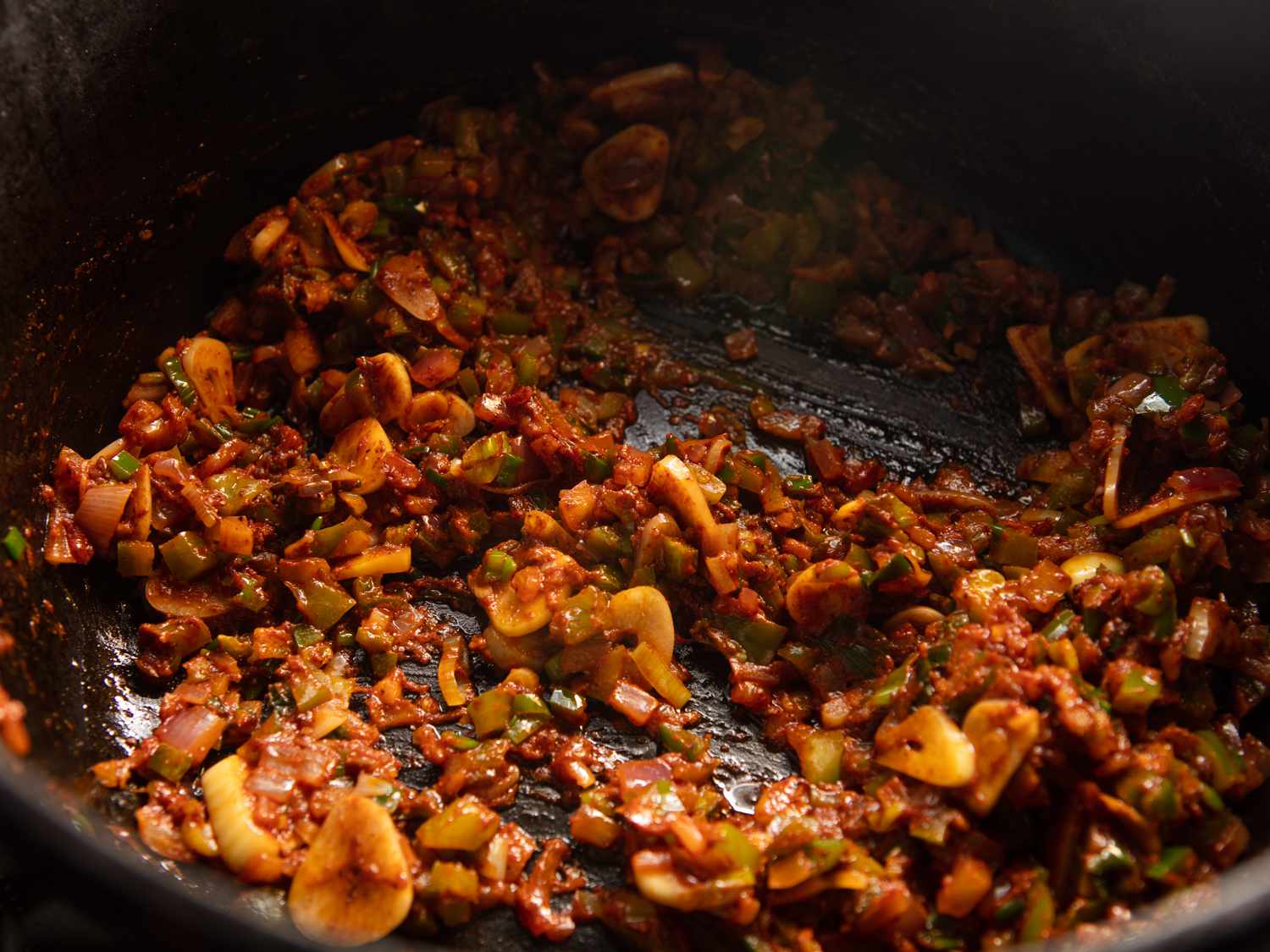 tomato paste, spices, and jalapeno peppers added to pot