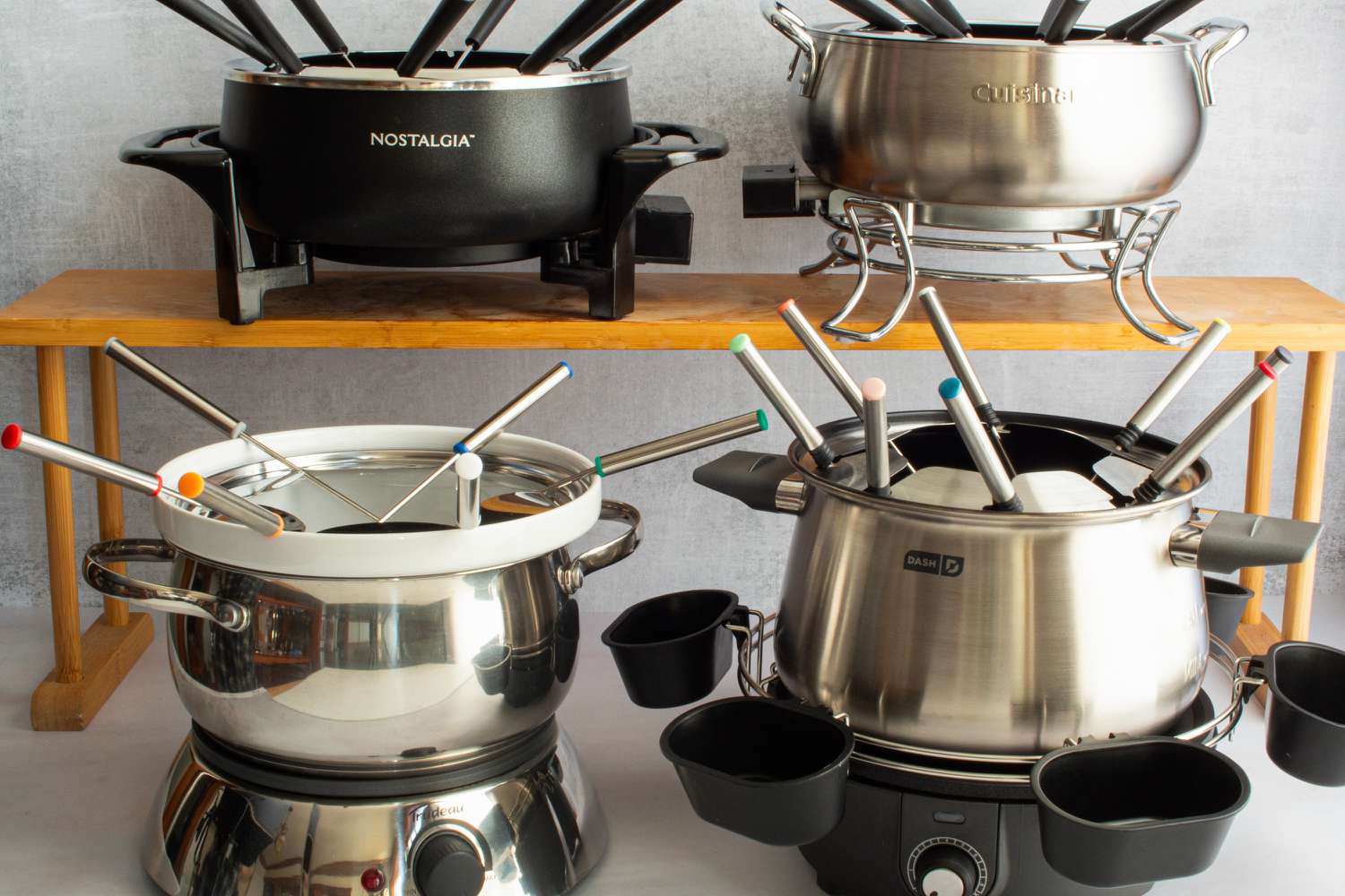 Four electric fondue pots.