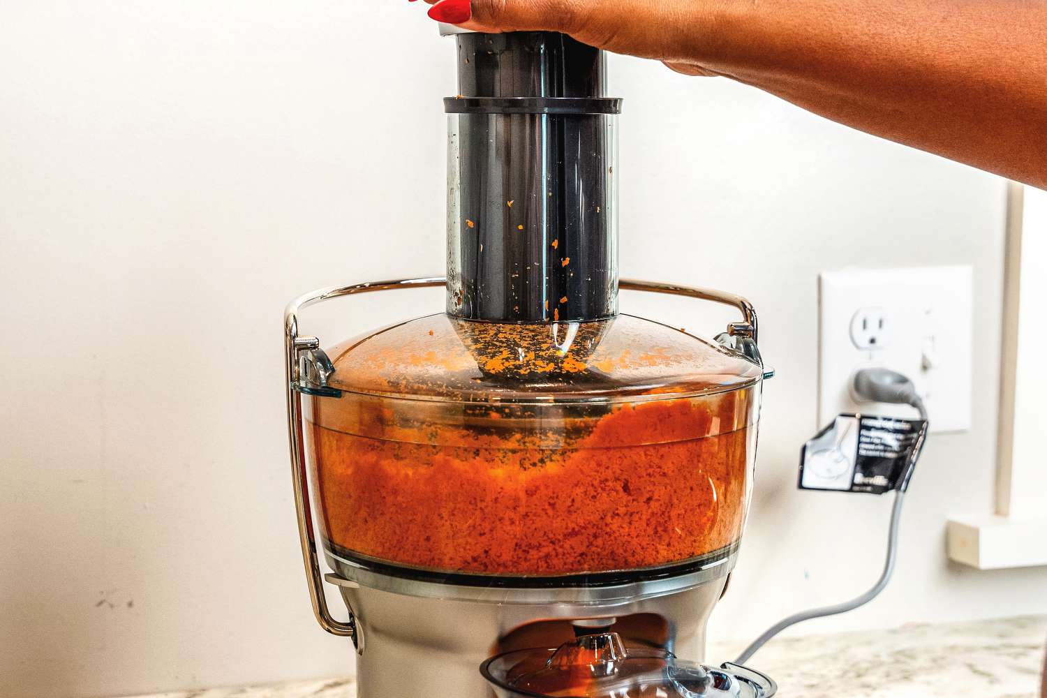 Carrot juice being processed in a Breville juicer
