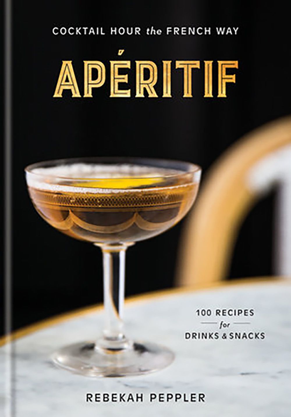 the cover of the book Aperitif: Cocktail hour The French Way featuring a coupe glass with a cocktail inside of it