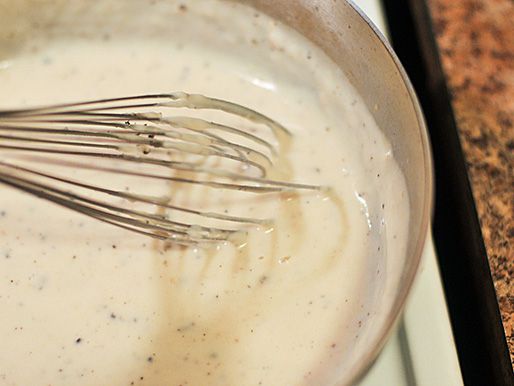 Milk and pepper are whisked into the roux until smooth.