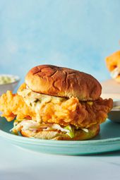 A fried fish sandwich covered in slaw.