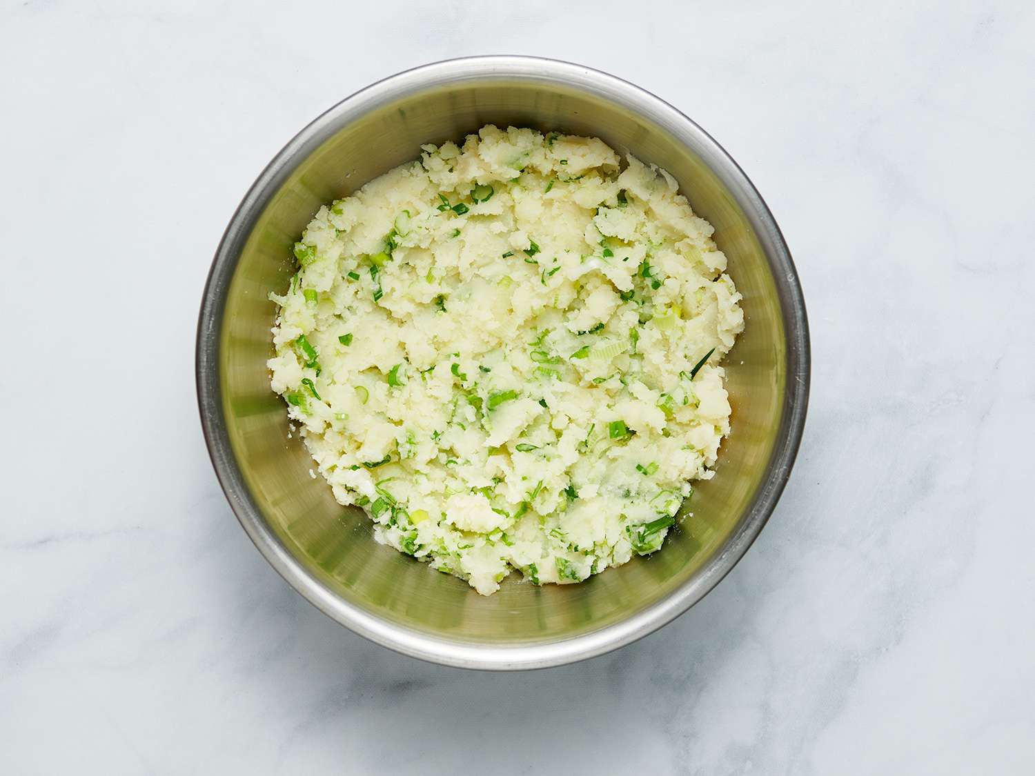 Potato knish filling in a large metal bowl 