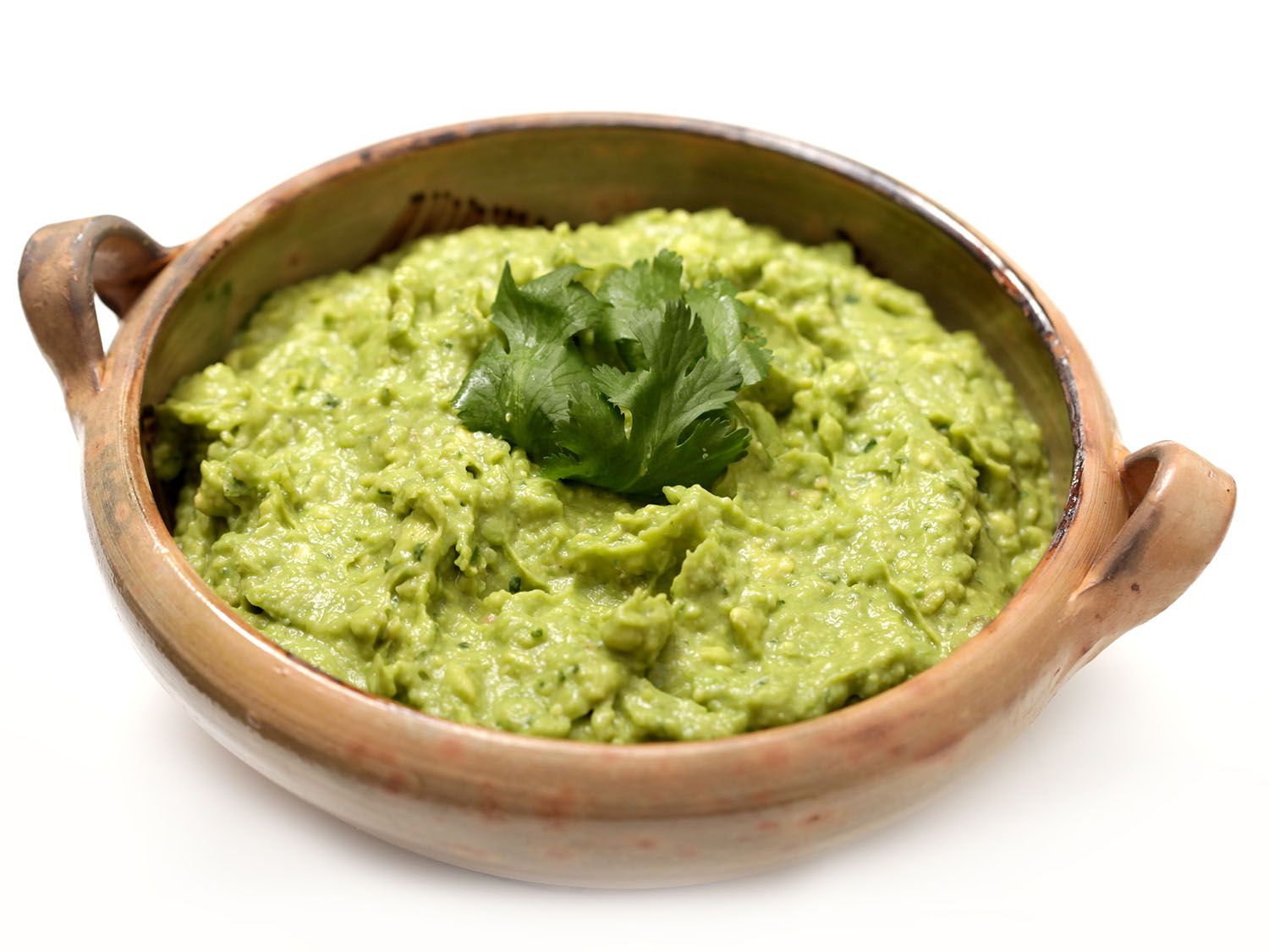 A crock of fresh green gaucamole in a crock.