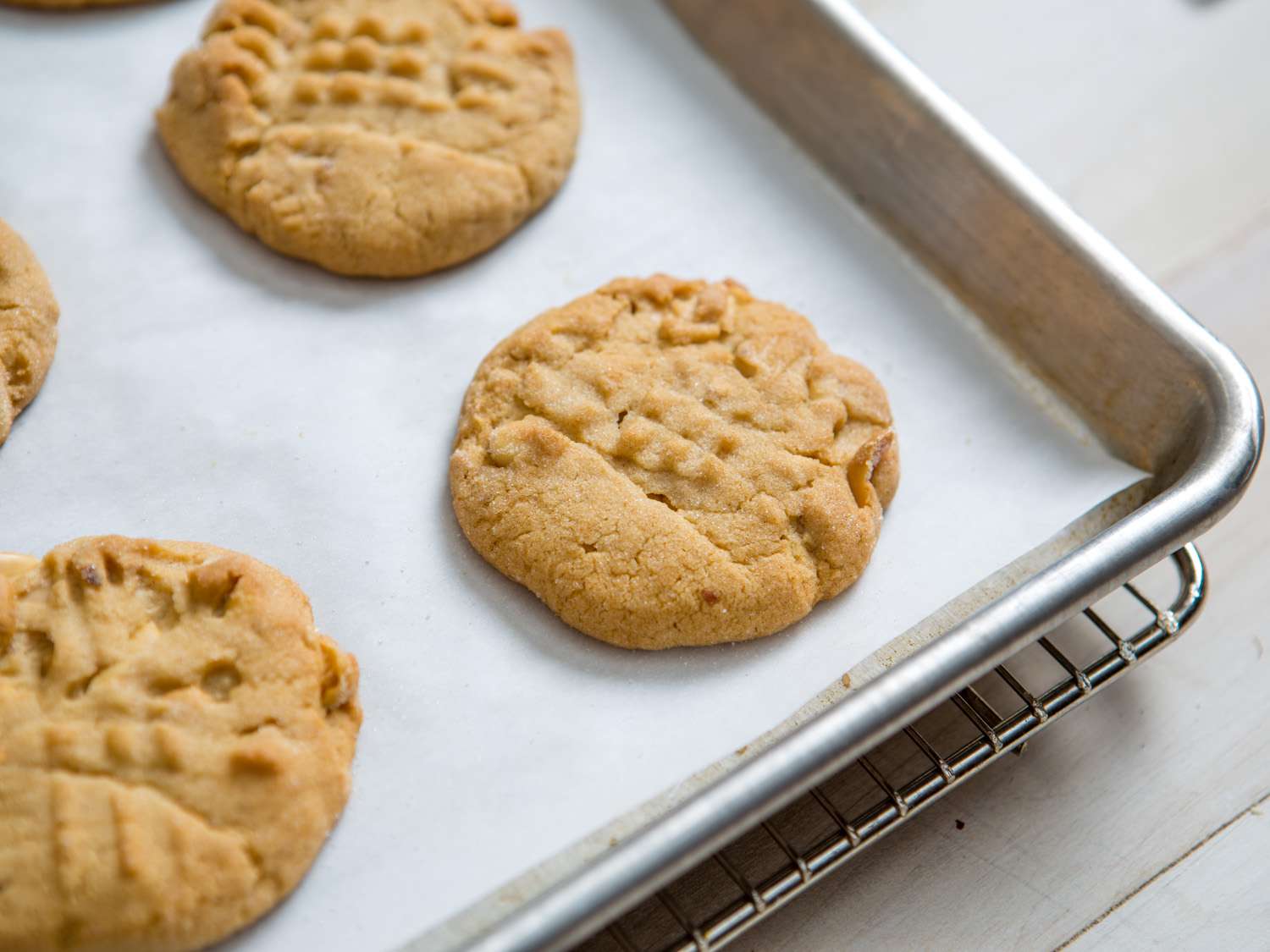 The finished peanut butter cookies, cooling on the baking sheet.