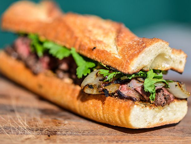 Grilled jalapeño-marinated baguette sandwich on wooden board 