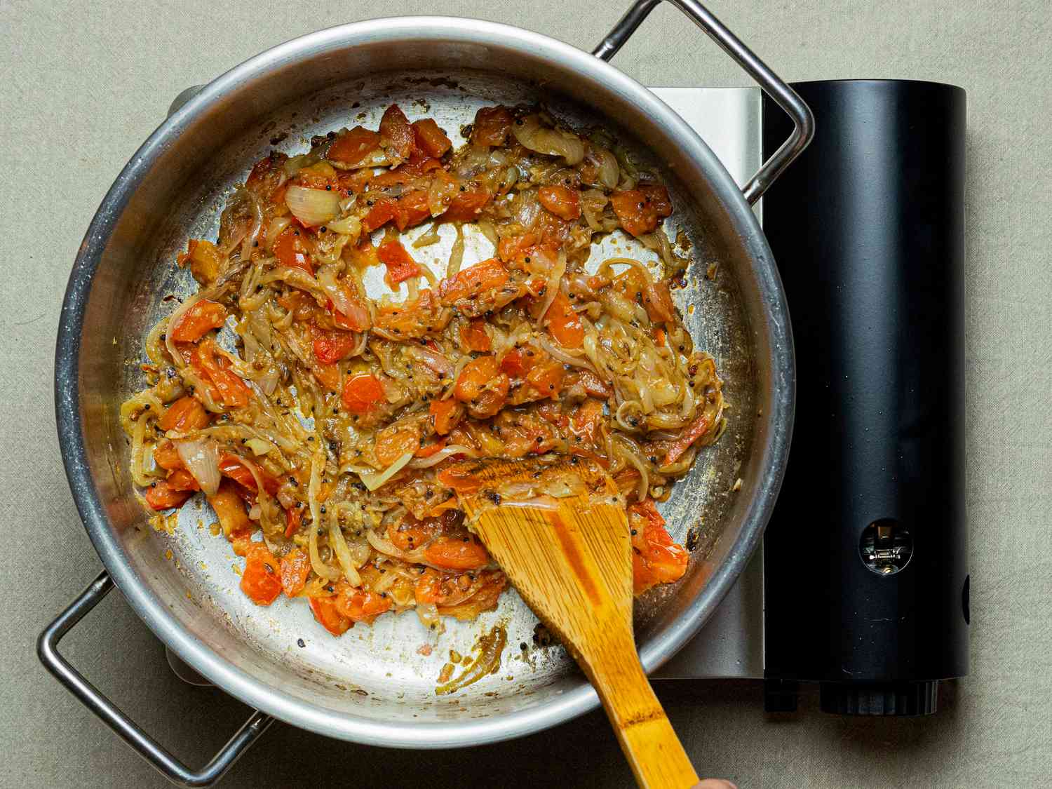 Overhead view of cooking onions in pan