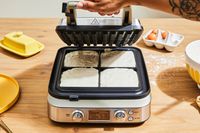 Person opening Breville The Smart Waffle Pro 4-Slice Waffle Maker