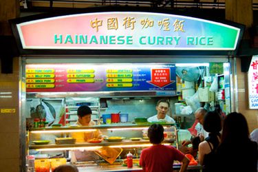 Hawker stand selling Hainanese curry rice in Singapore.