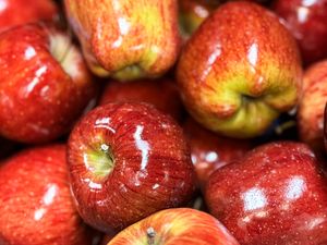 A collection of shiny red apples piled together