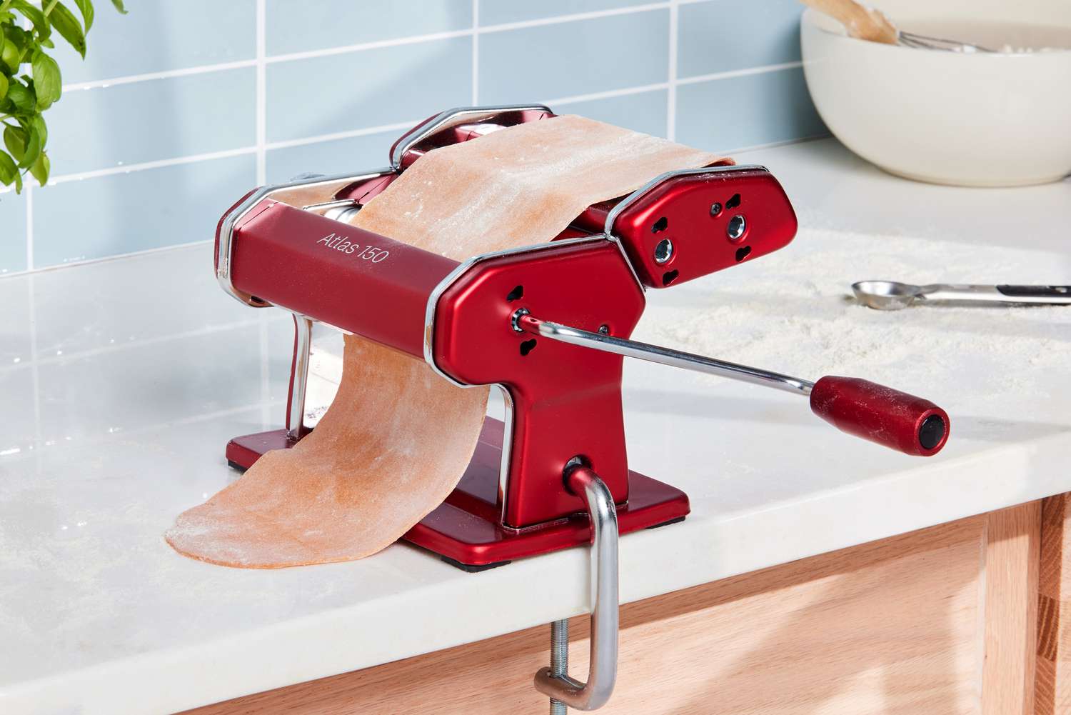 Pasta dough is fed through the Marcato Atlas 150 Pasta Machine with Motor