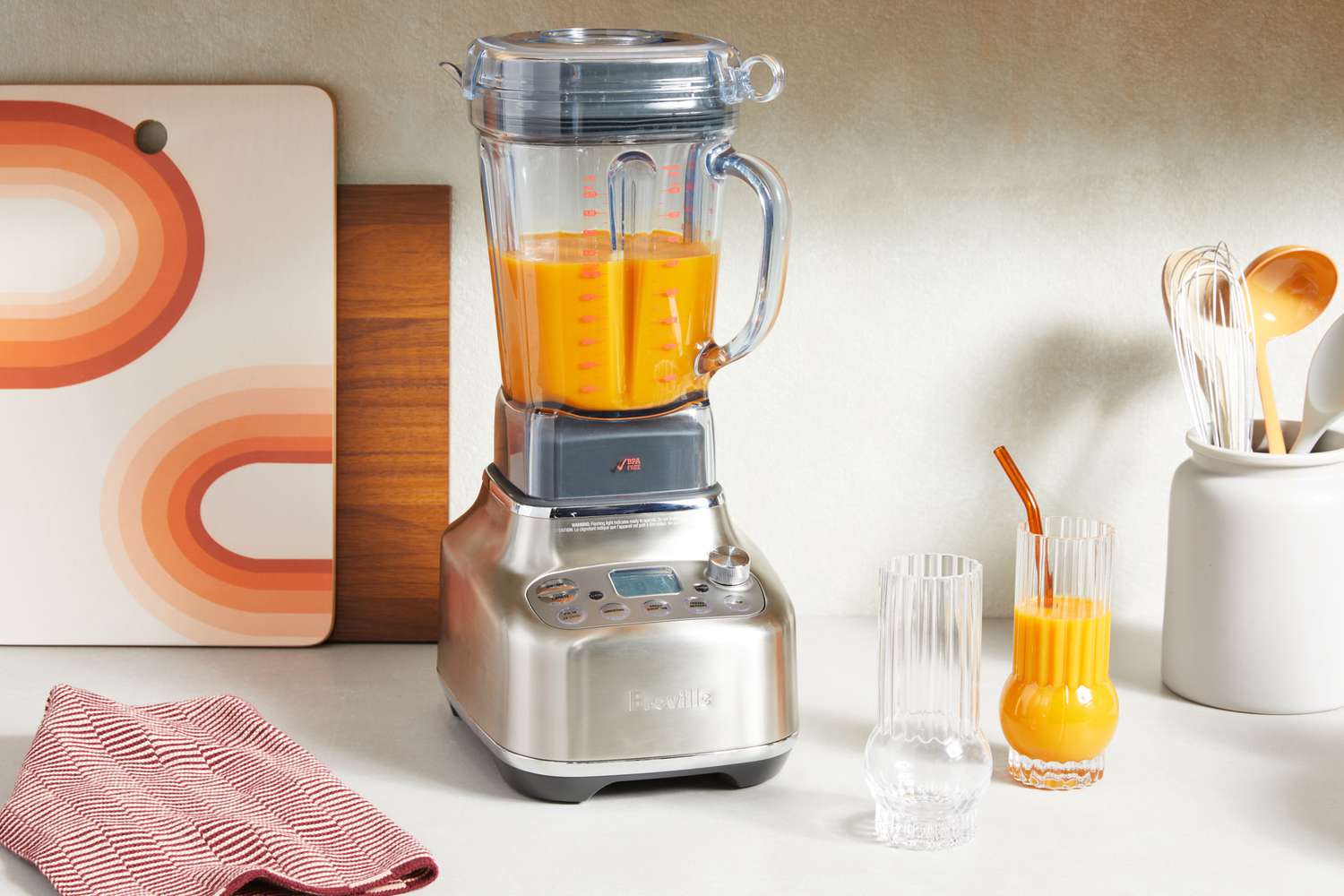 Orange liquid is blended in the Breville Stainless Steel Super Q Blender