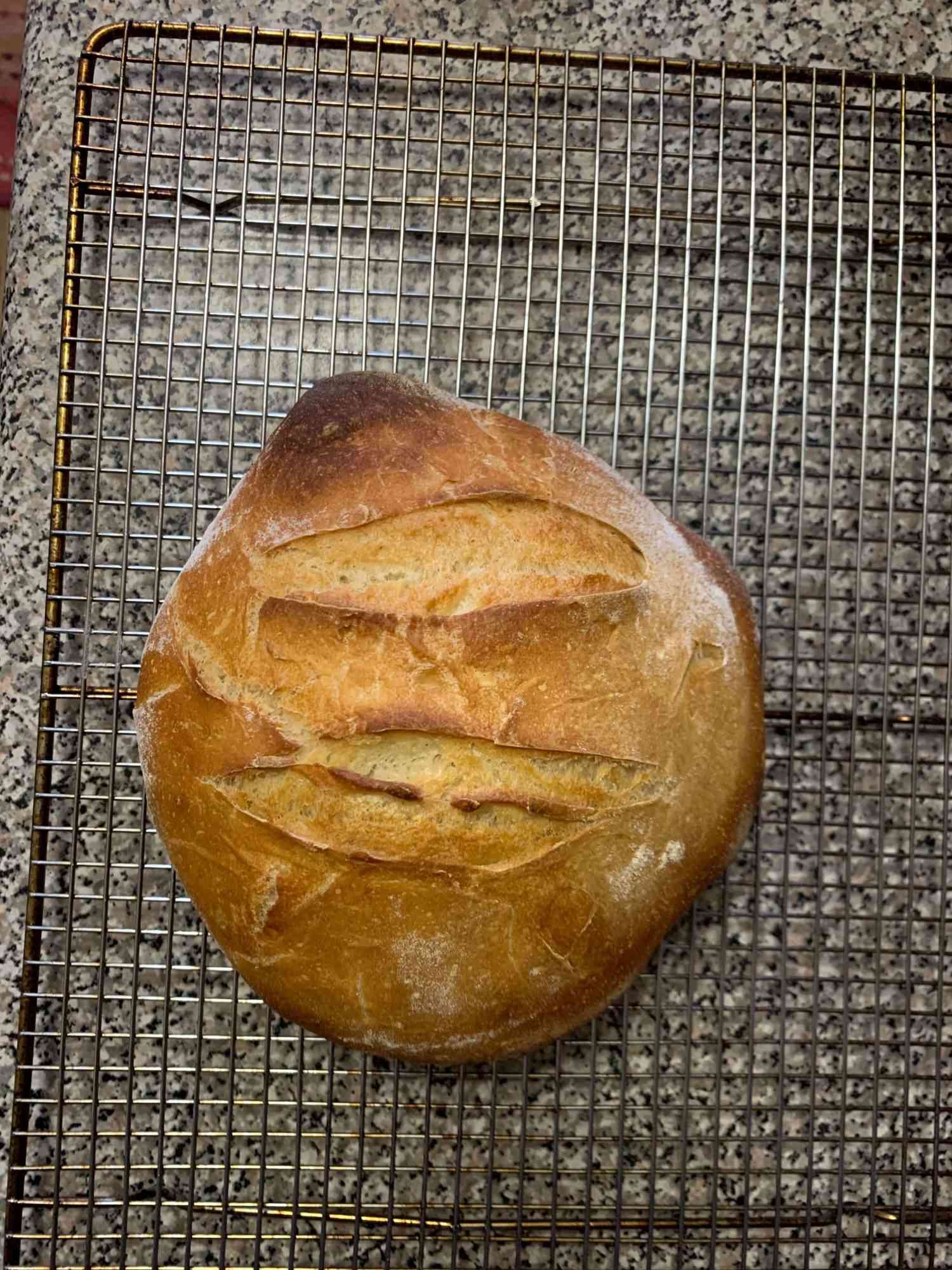 Overhead view of loaf of bread on a cooling rack