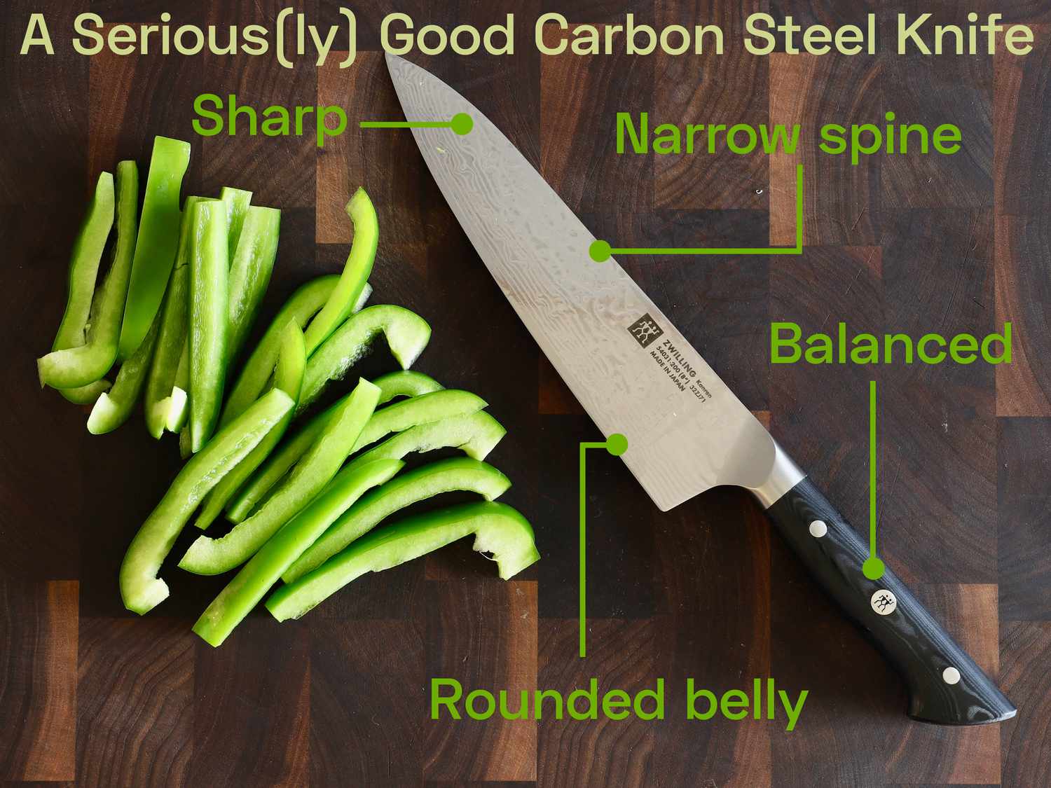 the zwilling kanren knife on a wooden cutting board with green peppers
