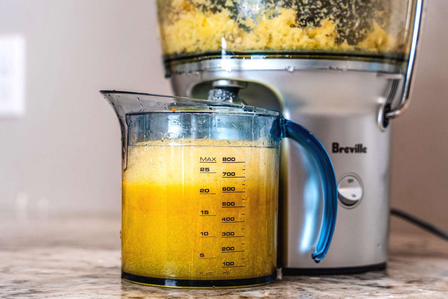 Ginger being juiced in a Breville juicer