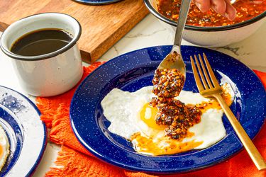 Side view of spooning salsa match onto eggs