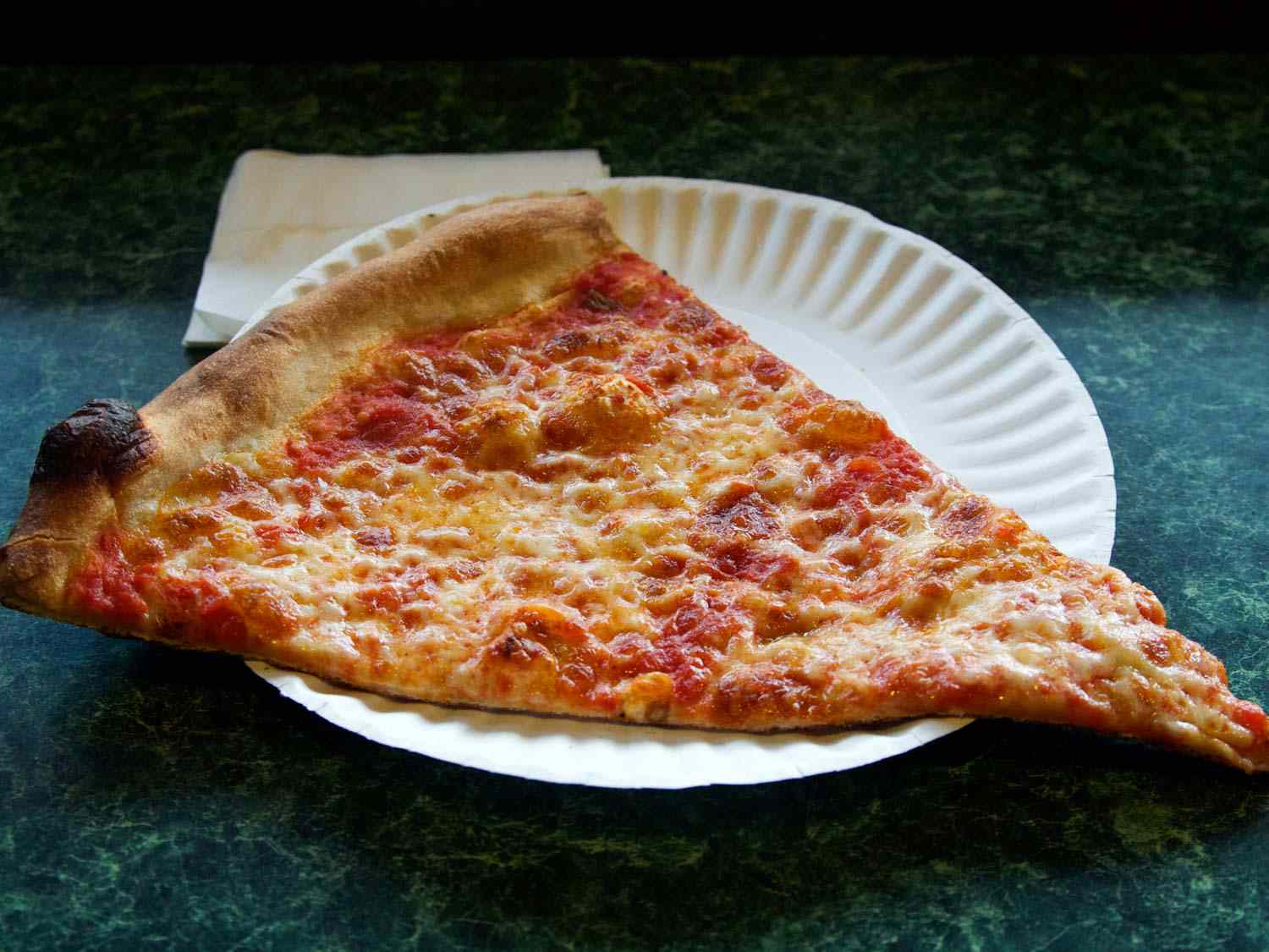 cheese slice on paper plate at Joe's