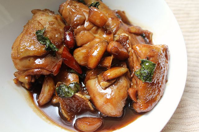 Three cup chicken in a white dish.