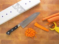 misono ux10 on a cutting board with the box and a cut up carrot