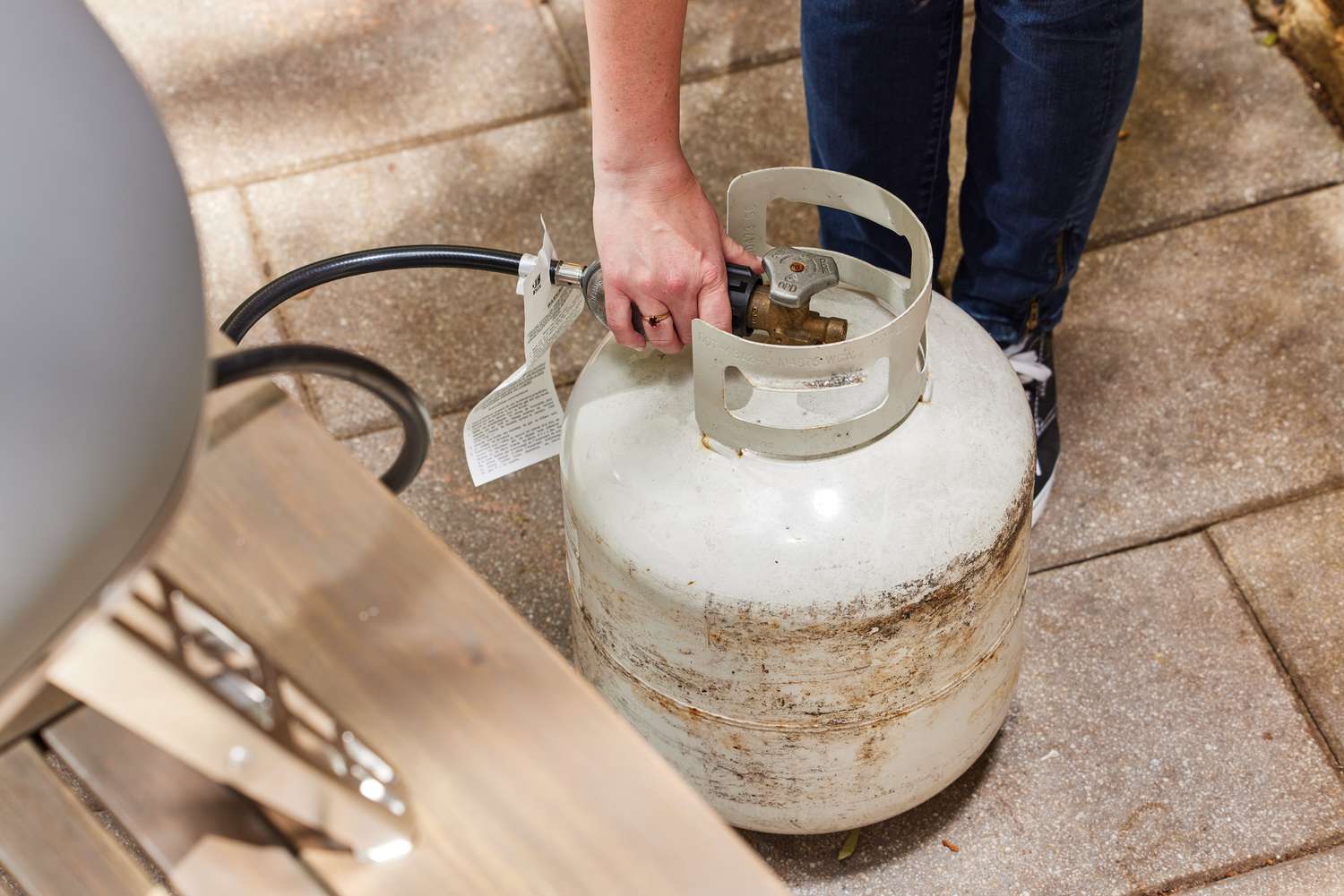 A hand connection the Gozney Roccbox Pizza Oven to a fuel tank